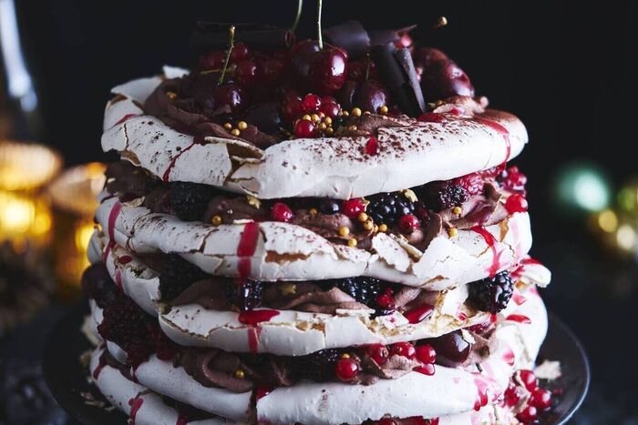 Showstopping meringue layer cake with chocolate cream and fresh berries