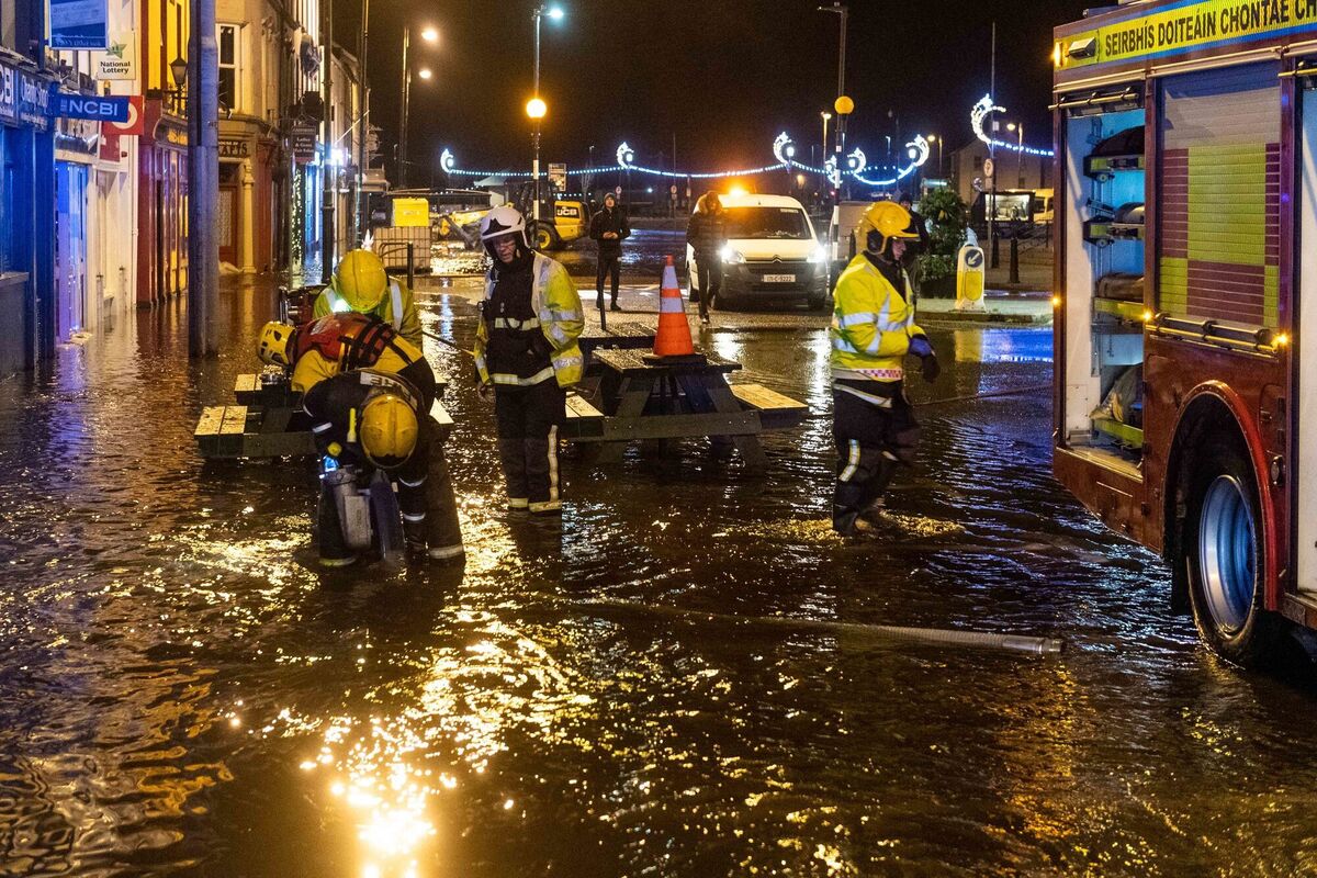 Members of the fire brigade pump away floodwater in Bantry. Photo: Andy Gibson/PA