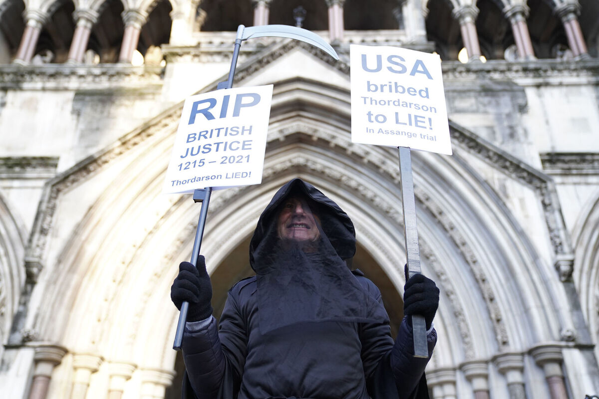 A supporter of Julian Assange demonstrates outside the Royal Courts of Justice in London. Picture: Kirsty O'Connor/PA Wire