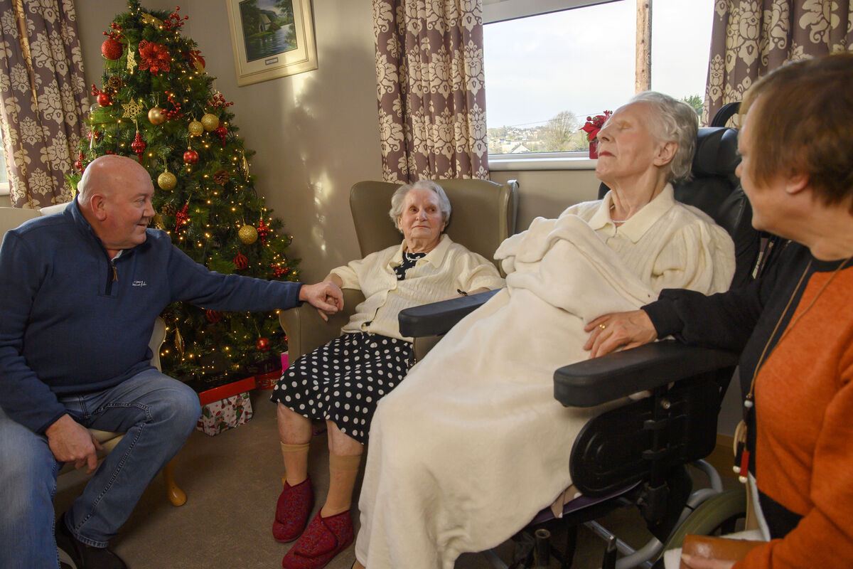 David and Miriam Dorgan (Kay's daughter) joined in the celebration for 99-year-old twin sisters Joan Barrett and Kay Bogan at Darraglynn Nursing Home, Cork City. Picture: Daragh McSweeney/Provision