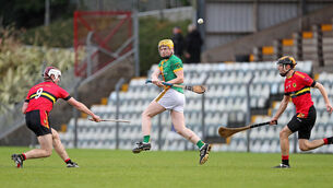 <p> Daniel Collins, Kilmoyley, get his shot away under pressure from Cian Hally and Darragh Murray, Dunhill. Picture: Jim Coughlan.</p>