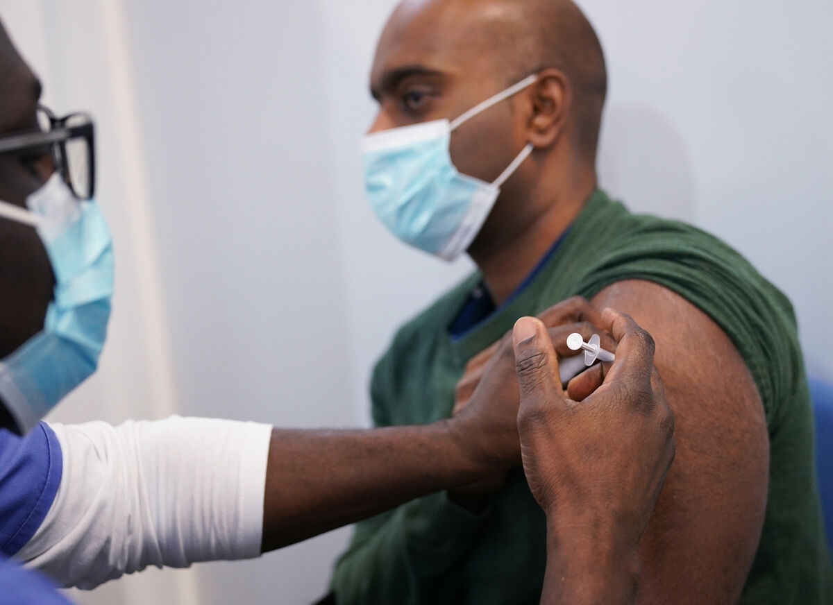A member of the public receives a Pfizer Covid-19 injection at a vaccination site in east London, as the government accelerates the Covid booster programme to help slow down the spread of the new Omicron variant. A member of the public receives a Pfizer Covid-19 injection at a vaccination site in east London, as the government accelerates the Covid booster programme to help slow down the spread of the new Omicron variant.