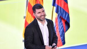 <p>Barcelona's Argentinian forward Kun Aguero smiles as he addresses a press conference to announce his retirement from football, at the Camp Nou stadium in Barcelona, on December 15, 2021. Photo by PAU BARRENA/AFP via Getty Images)</p>