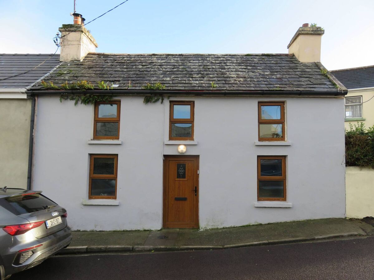 Eye-catching...but bushy looking 'eyebrows' in roof and gutters at this Schull centre townhouse 