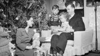 Family opening Christmas presents, children (2-3) (4-5), (B&W)