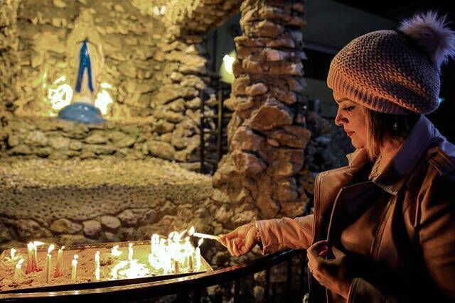 An Iraqi Christian woman lights candles at St Teresa’s Church in Basra, Iraq (Nabil al-Jurani/AP) An Iraqi Christian woman lights candles at St Teresa’s Church in Basra, Iraq (Nabil al-Jurani/AP)