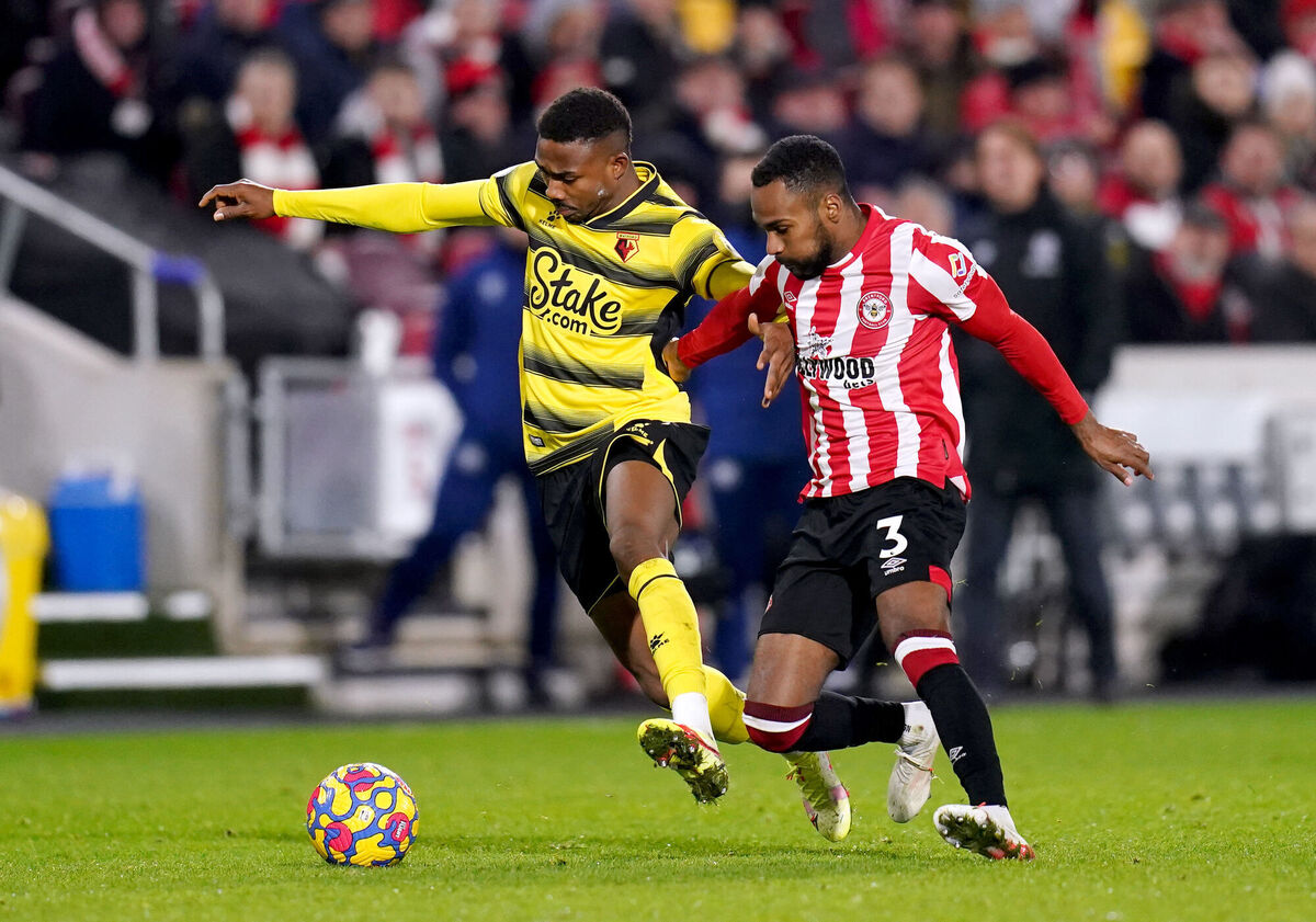 Watford's Emmanuel Dennis (left) and Brentford's Rico Henry battle for the ball during their Premier League match at the Brentford Community Stadium, London. Picture: John Walton/PA