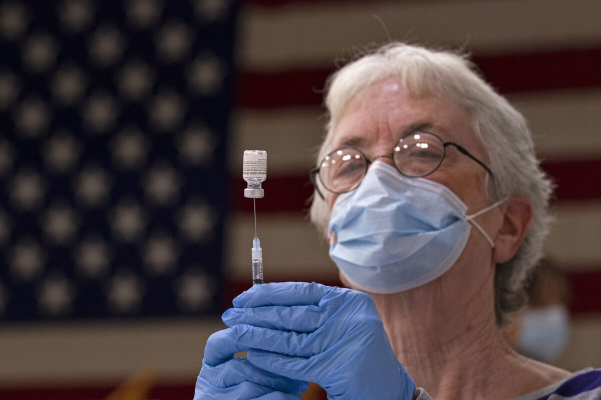 Pam Hetherly fills a syringe with COVID-19 vaccine at a clinic at the Augusta Armory, Maine.
