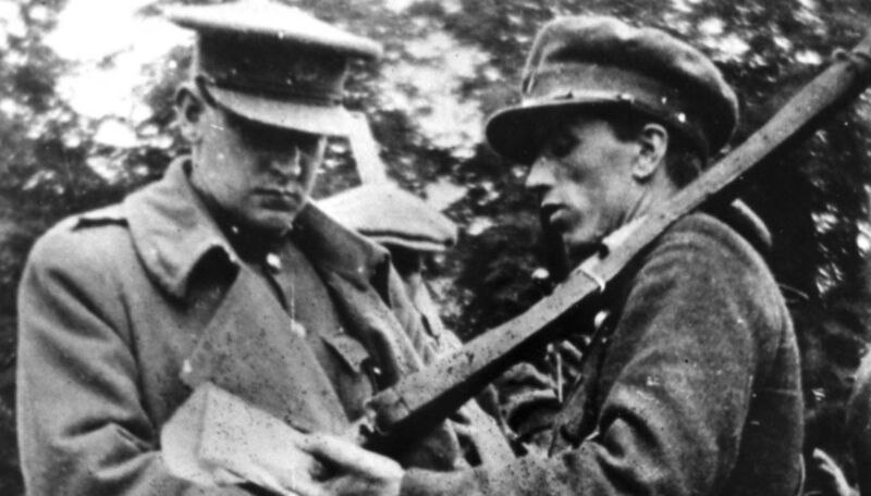 Michael Collins (left) with a Free State soldier. “Will any man stand up in this assembly and tell me that he would have refused to sign, and would by his refusal commit these 25 men to death, and commit the country generally to further bloodshed and destruction?” Michael Collins (left) with a Free State soldier. “Will any man stand up in this assembly and tell me that he would have refused to sign, and would by his refusal commit these 25 men to death, and commit the country generally to further bloodshed and destruction?”