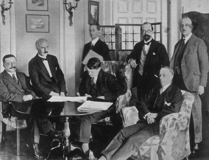(Seated left to right at the signing of the Treaty on December 6, 1921) Sinn Fein founder Arthur Griffith, E.J. Duggan, Irish Minister for Finance Michael Collins and politician Robert Barton. (Standing left to right) Author Robert Erskine Childers, lawyer George Gavan Duffy and John Chartres. Collins famously expressed the belief that in so doing he had signed his own death warrant. Photo: Topical Press Agency/Getty Images