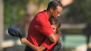 <p>BACK ON TRACK: Tiger Woods hugs his son, Charlie after they'd completed the final round at the PNC Championship in Orlando last month.</p>