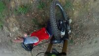 VIDEO: Downhill mountain biker crashes into kid on track