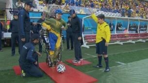 Paraplegic in robotic suit made the first kick of the World Cup last night
