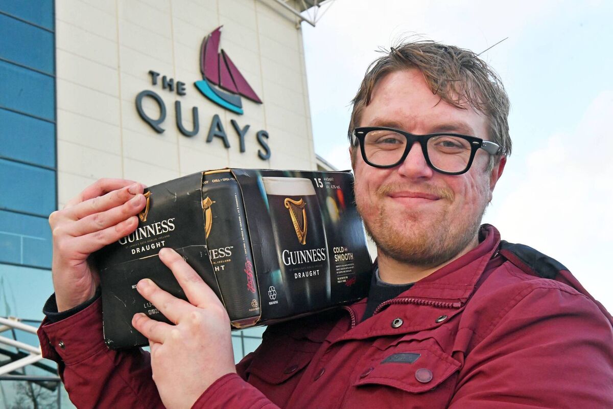Irish Examiner reporter Sean Murray bags a bargain in Newry. The first thing to note is that the quantities of beer and cider are often slightly smaller than in the Republic of Ireland. Photo: Alan Lewis