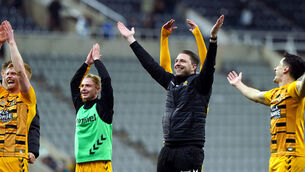 <p>Cambridge United manager Mark Bonner (centre) celebrates with players after their shock win over Newcastle (Owen Humphreys/PA)</p>