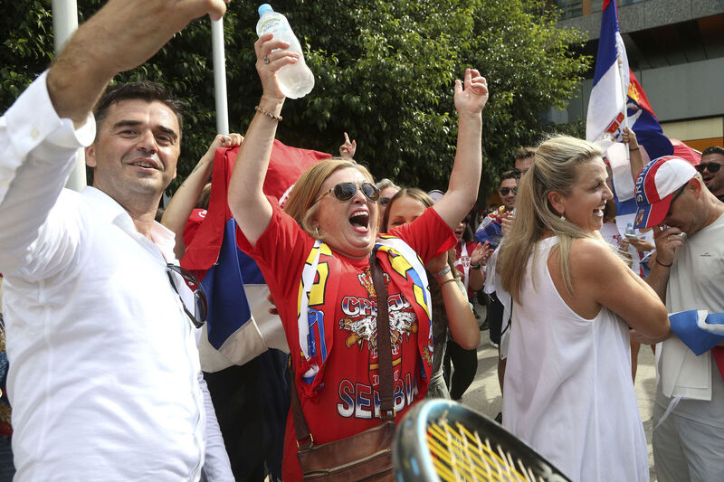 Fans of Serbia's Novak Djokovic react to news of his overturned ruling outside Federal Court ahead of the Australian Open in Melbourne, Australia, Monday, Jan. 10, 2022. Picture: AP Photo/Hamish Blair