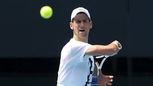 <p>Novak Djokovic’s participation at the Australian Open remains in doubt (Kelly Defina/AP)</p>