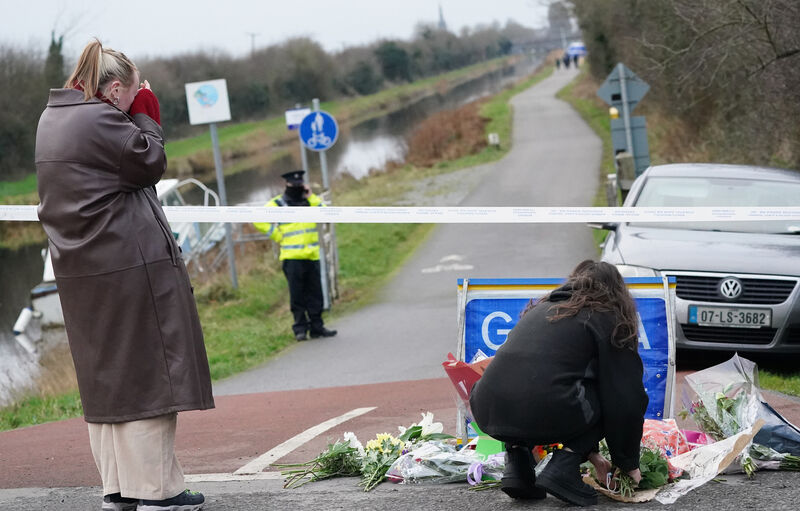 A person lays flowers near to the scene in Tullamore, Co Offaly, after Ashling Murphy, a primary school teacher aged in her 20s, was killed on Wednesday afternoon along the banks of the Grand Canal at Cappincur, Co Offaly. 