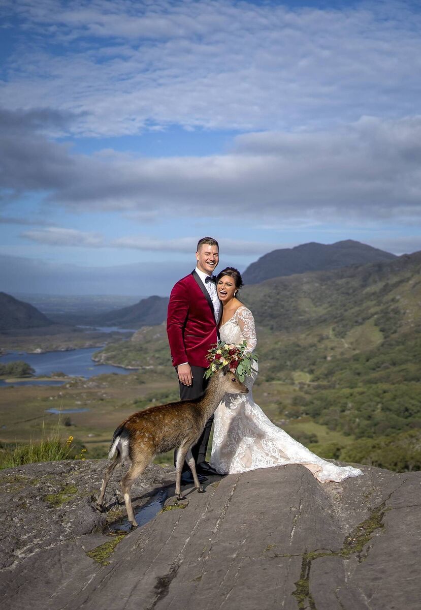 Melanie Joughalian and Lachlan Porteous are photobombed by a deer at Ladies View, Killarney in 2019. Picture: Adrian O'Neill 