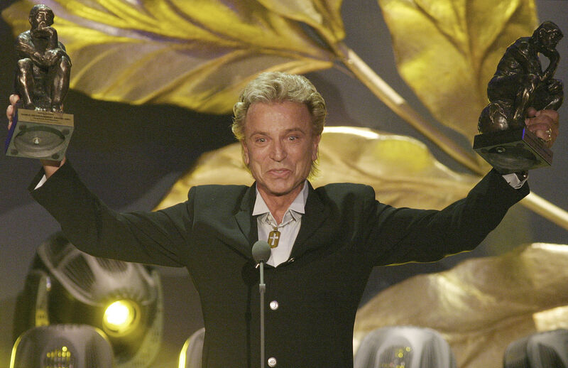 German illusionist Siegfried Fischbacher holds the duo's trophies after receiving the World Entertainment Award at the World Award 2003 ceremony in Hamburg, northern Germany in 2003. German illusionist Siegfried Fischbacher holds the duo's trophies after receiving the World Entertainment Award at the World Award 2003 ceremony in Hamburg, northern Germany in 2003.