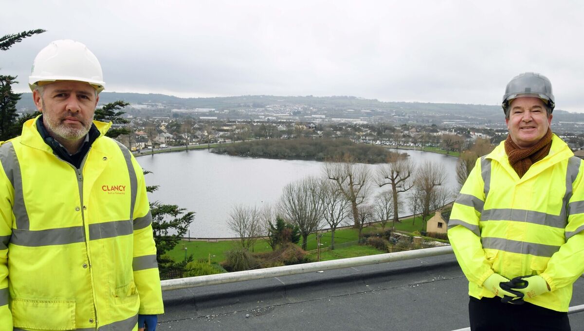 Garret Nestor, contracts manager, (left) and Des Riordan, associate director, Clancy Construction, against the backdrop of the Lough from the top of one section of Ashlin House student accommodation