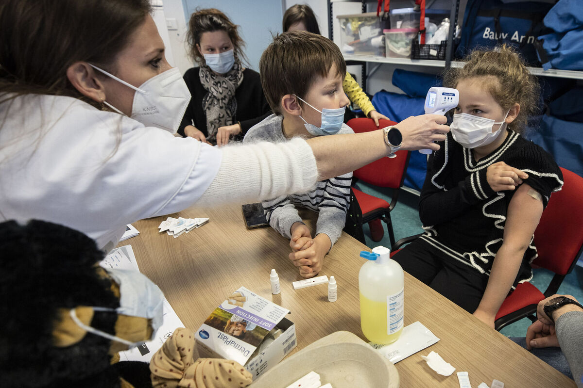 A medical staff takes the temperature to a child in a vaccine centre in Sélestat, eastern France.