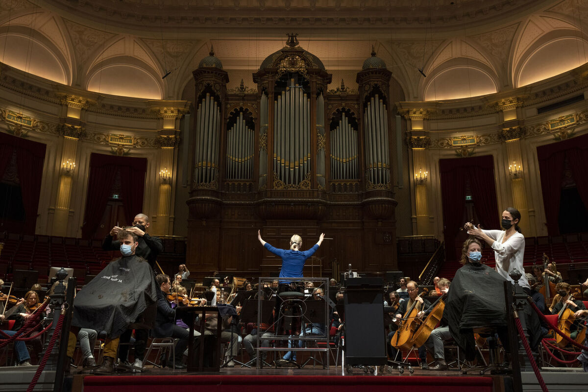 People get a haircut during a rehearsal at the Concertgebouw in Amsterdam on Wednesday, as Dutch museums, theatres and concert halls played host to businesses that are allowed to open to customers as a protest against their own continuing lockdown closures.