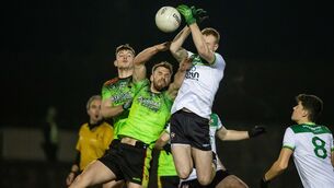 <p>IT Carlow’s Tommy Griffin with Sean McCarthy of Queens. Picture: INPHO/Morgan Treacy</p>