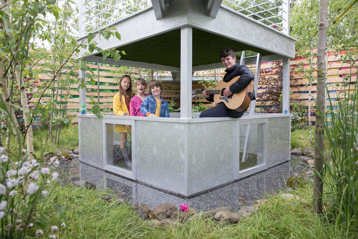 Super Garden judge and former Bloom winner Brian Burke at Bloom Festival with Adela Pak and Ruby and Flynn with busker Sam Clifford. Picture: Paul Sharp Super Garden judge and former Bloom winner Brian Burke at Bloom Festival with Adela Pak and Ruby and Flynn with busker Sam Clifford. Picture: Paul Sharp