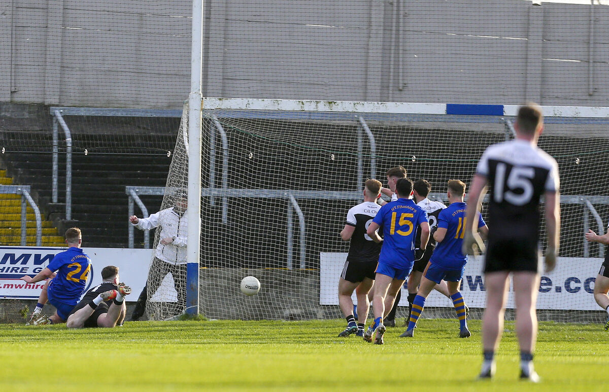 St Finbarr’s Eoin McGreevy shoots past Kilcoo’s Niall Kane. Picture: INPHO/Ken Sutton