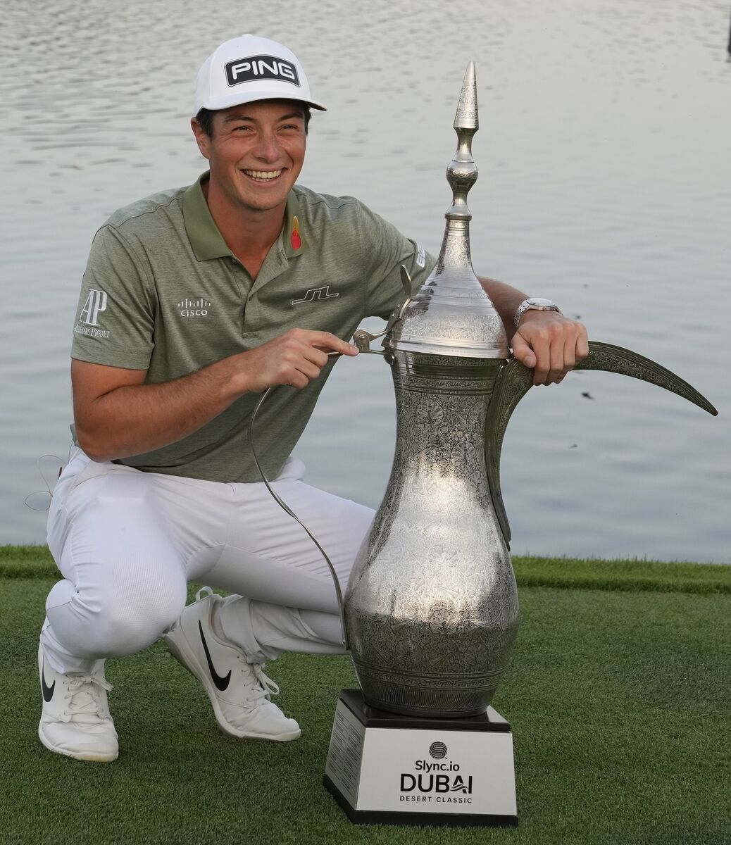 Viktor Hovland of Norway holds the trophy after he won the Dubai Desert Classic. Picture: AP Photo/Kamran Jebreili