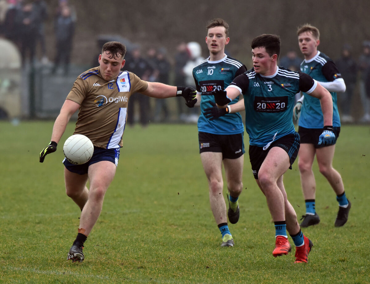 MTU (Kerry) forward Dara Moynihan shoots past Maynooth University’s Kieran Dolan. Picture: Eddie O’Hare