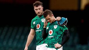 <p>Ireland's Will Connors consoles Billy Burns after the the defeat to Wales last season</p>