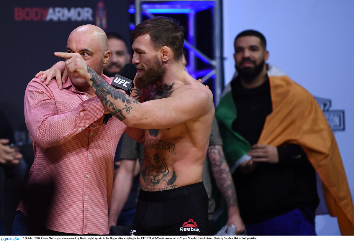 Conor McGregor, accompanied by Drake, right, speaks to Joe Rogan after weighing in for UFC 229 at T-Mobile Arena in Las Vegas, Nevada, in 2018. Photo by Stephen McCarthy/Sportsfile