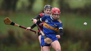 <p>Tipperary's Sarah Delaney with Cassie Fitzpatrick of Down</p>
