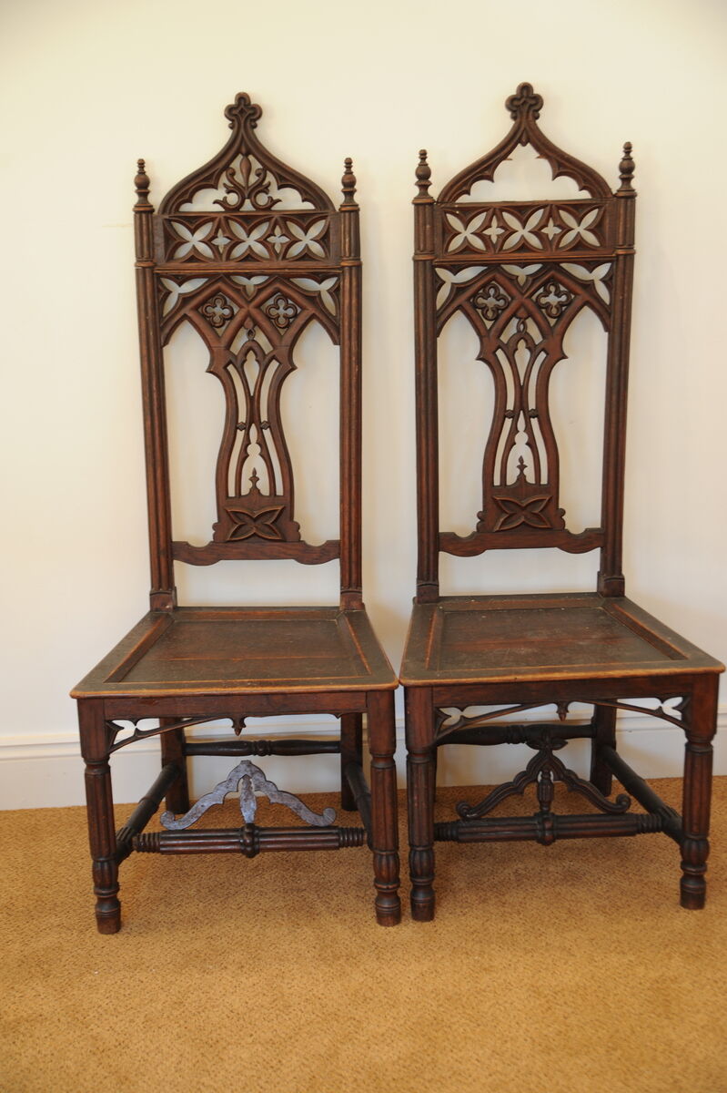A pair of 19th-century Gothic oak carved high-back chairs.