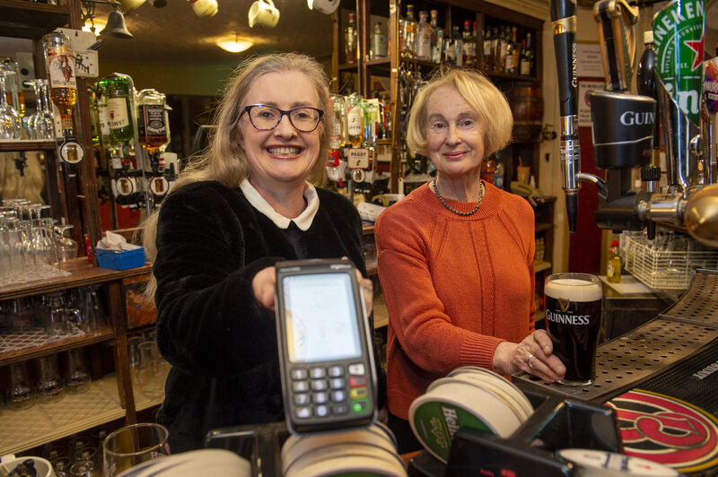 Back behind the bar with her mother Nancy, Rachel O'Donnell-Barry proffers one of the innovations at the reopened Hi-B, a credit card machine. Picture: Dan Linehan Back behind the bar with her mother Nancy, Rachel O'Donnell-Barry proffers one of the innovations at the reopened Hi-B, a credit card machine. Picture: Dan Linehan