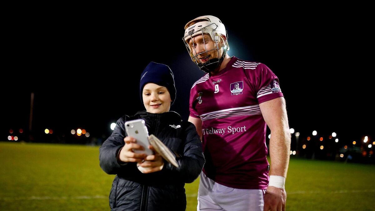 Cian Lynch of NUIG poses for a selfie with a young fan after a Fitzgibbon Cup game. Picture: Stephen McCarthy/Sportsfile