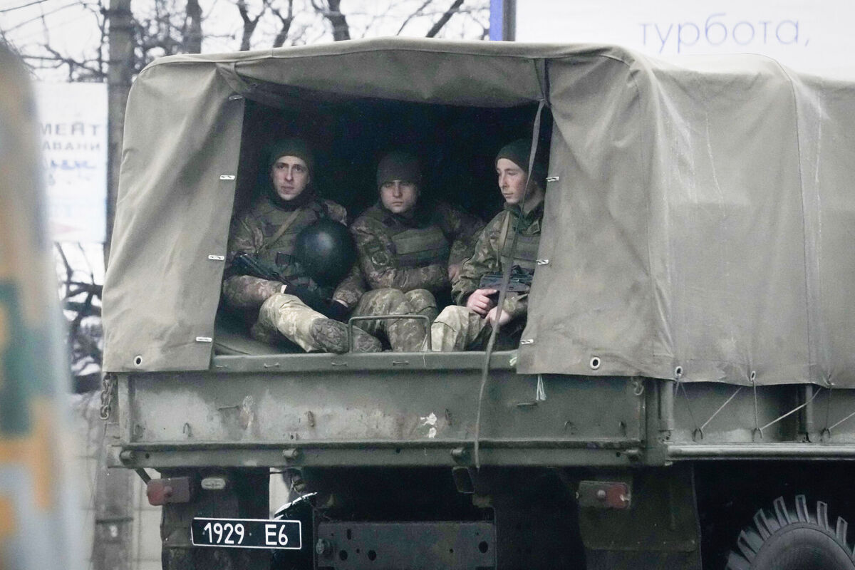 Ukrainian soldiers ride in a military vehicle in Mariupol, Ukraine, Thursday. Picture: AP Photo/Sergei Grits
