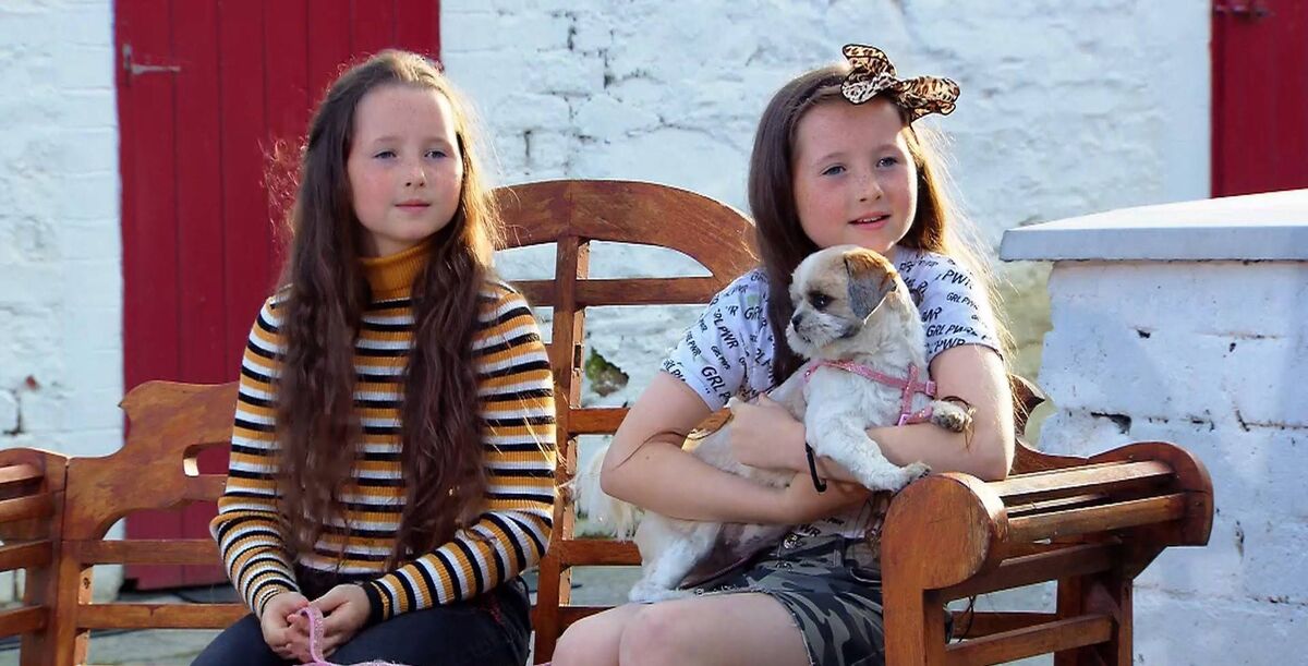 Twins Éabha and Caoimhe with their Shih-tzu Aibí