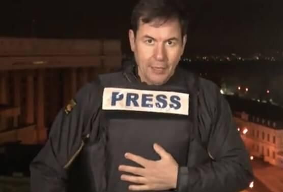 Matthew Chance was talking live on CNN to anchor Don Lemon from the rooftop of a hotel in Kyiv when the bombs started falling behind him causing him to hurriedly don his flak jacket. Picture: CNN video