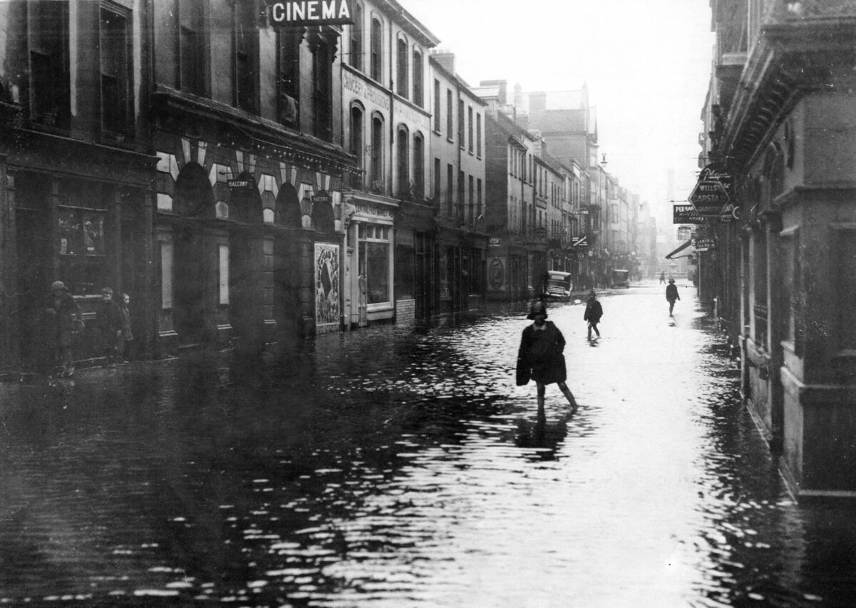 In Oliver Plunkett Street, the children enjoy splashing through the rising waters. 