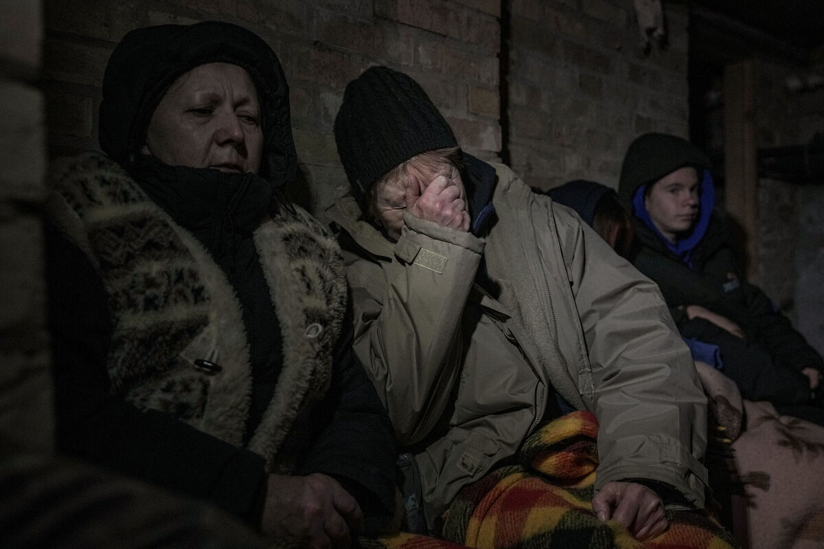 A woman cries in the small basement of a house crowded with people seeking shelter from Russian airstrikes, outside the capital Kyiv, Ukraine. Picture: Vadim Ghirda/PA