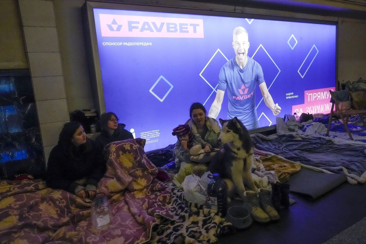 A family with their dog sit in the Kyiv subway, using it as a bomb shelter in Kyiv, Ukraine. Picture: AP Photo/Efrem Lukatsky