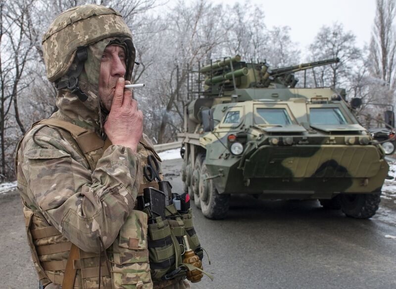 A Ukrainian soldier at his position near an armoured vehicle as the Ukrainian army vowed to keep fighting. Picture: Andrew Marienko/AP