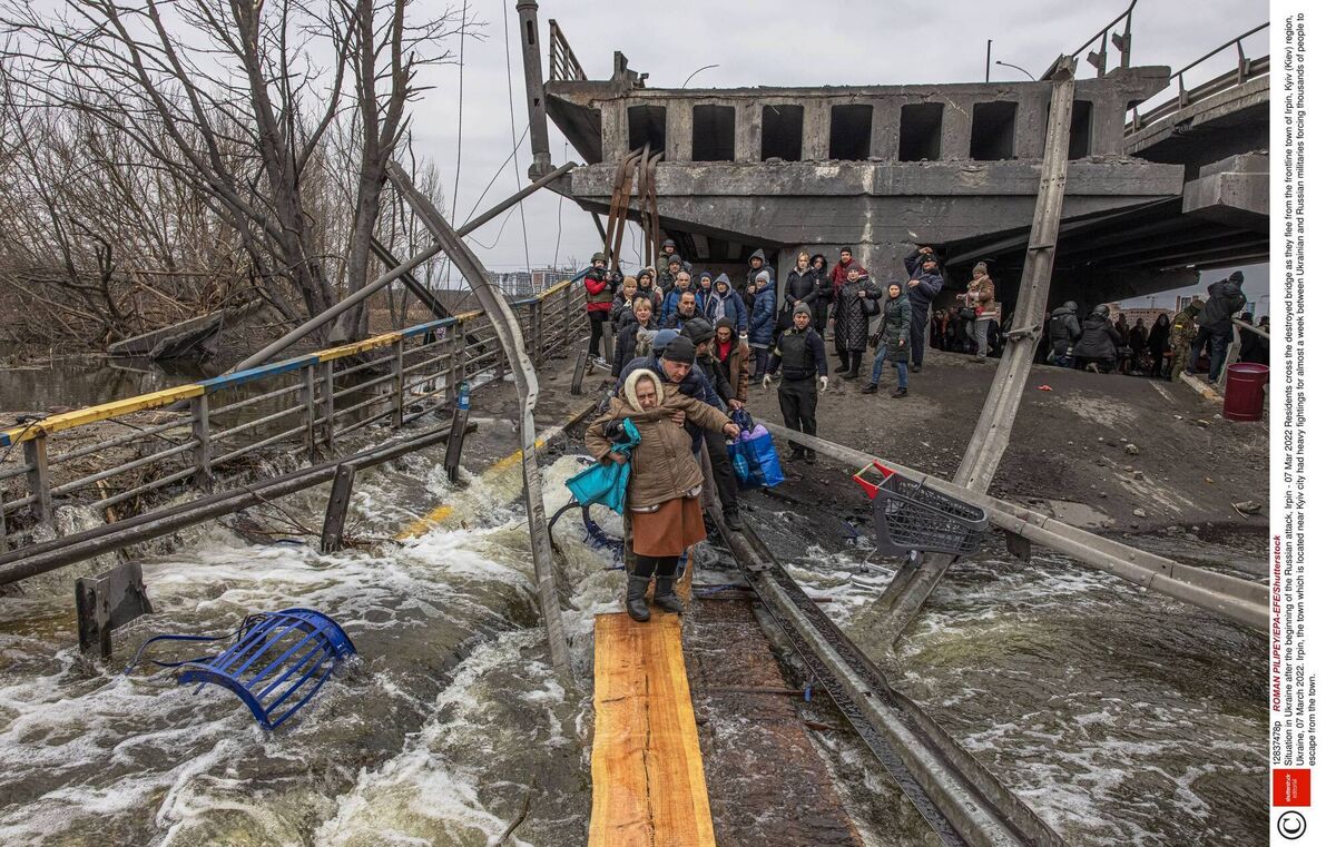Residents cross the destroyed bridge as they flee from the frontline town of Irpin, Kyiv, Ukraine, yesterday. Picture: Shutterstock Residents cross the destroyed bridge as they flee from the frontline town of Irpin, Kyiv, Ukraine, yesterday. Picture: Shutterstock