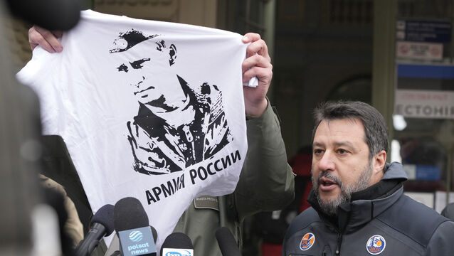 The Mayor of Przemysl, Wojciech Bakun, left, holds up a t-shirt with the likeness of Russian President Vladimir Putin and the words “The Russian Army” as Italy’s League Party leader, Matteo Salvini, right, speaks with journalists outside the train station in Przemysl, Poland, Tuesday, March 8, 2022. Matteo Salvini was confronted Tuesday by the mayor of Przemysl, Wojciech Bakun, during a news conference outside the train station where many of the more than 2 million refugees from war in Ukraine have come in recent days. (AP Photo/Czarek Sokolowski)