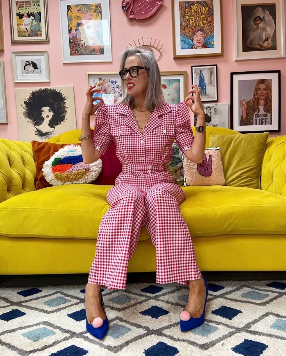 Joanne Mooney on her yellow Windsor velvet sofa from Joules at DFS. 