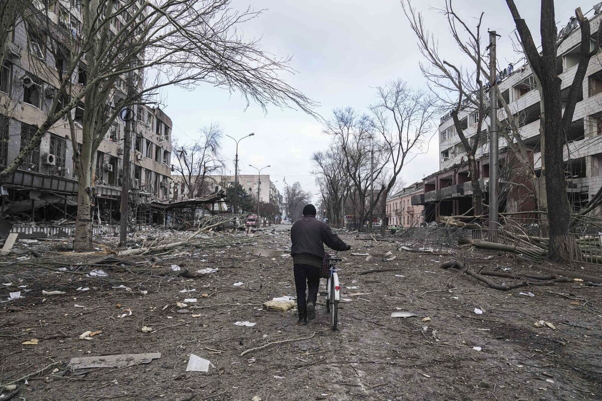 A man walks with a bicycle in a street damaged by shelling in Mariupol, Ukraine. Picture: AP Photo/Evgeniy Maloletka