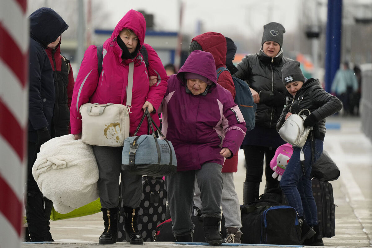 People carry their belongings after fleeing the war from neighbouring Ukraine at the border crossing in Palanca, Moldova, on Friday. Photo: AP/Sergei Grits People carry their belongings after fleeing the war from neighbouring Ukraine at the border crossing in Palanca, Moldova, on Friday. Photo: AP/Sergei Grits